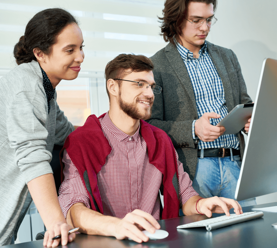 three-young-people-in-the-office-looking-at-computer-working-studying-clasrrom-lab-room